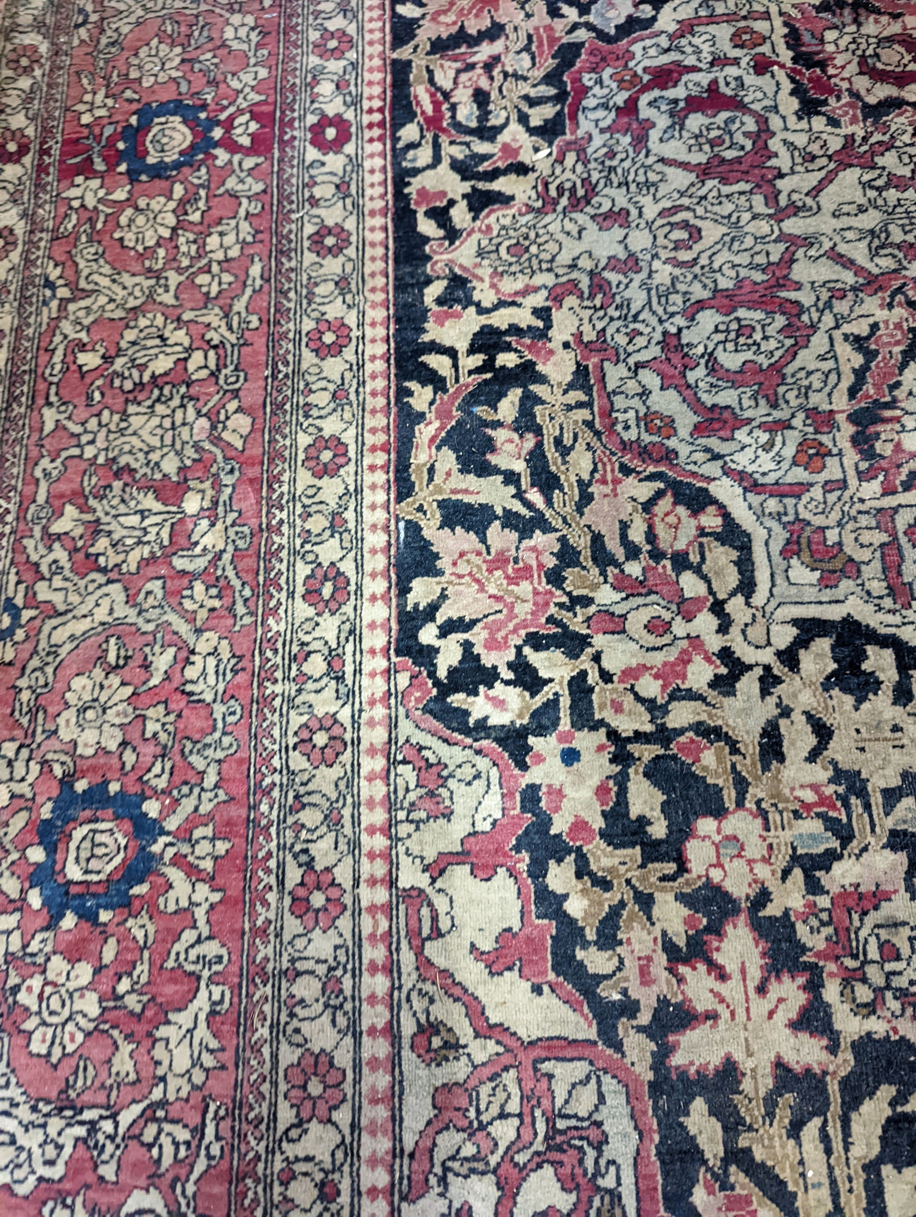 An Isphahan black ground rug with central foliate medallion, mulit-bordered, 202 x140cm